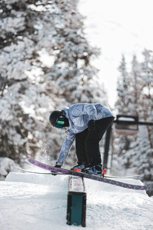 a snowboarder on a rail doing a trick