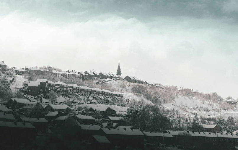 a town on a snowy mountain with houses along the side