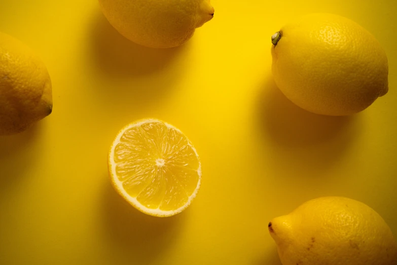 some very big and juicy lemons with one cut in half