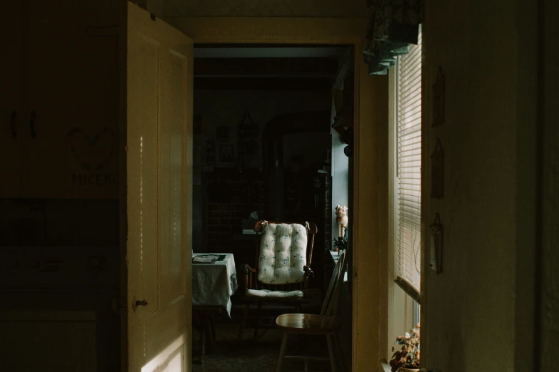 the interior of an apartment with only a chair and no closet doors