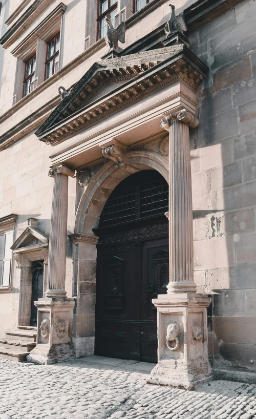 the outside of an old building with columns