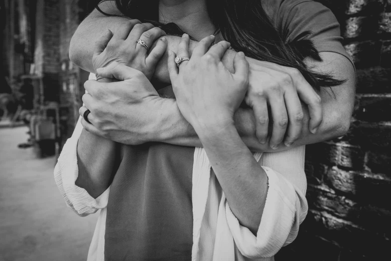 a black and white po of two women holding each other