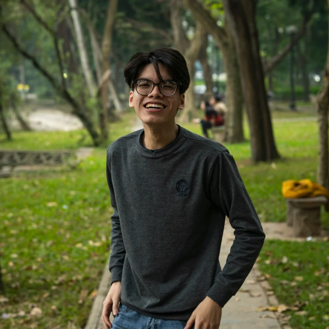 a man stands smiling as he walks down the street