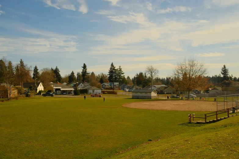 a baseball field sits empty during the daytime