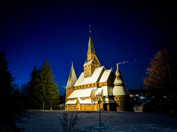 a small church on a hill with a large clock