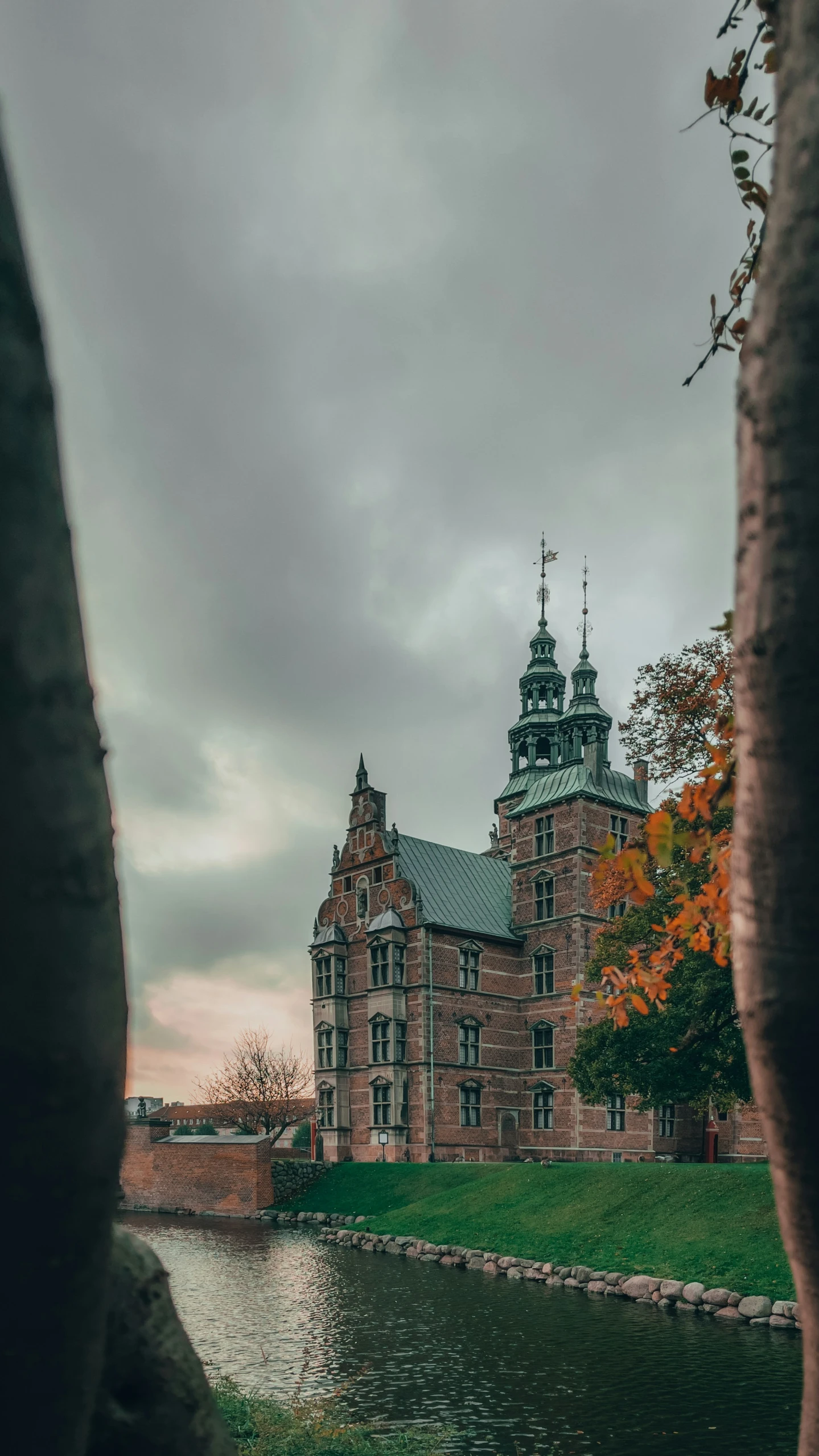 an old building sitting on the side of a river