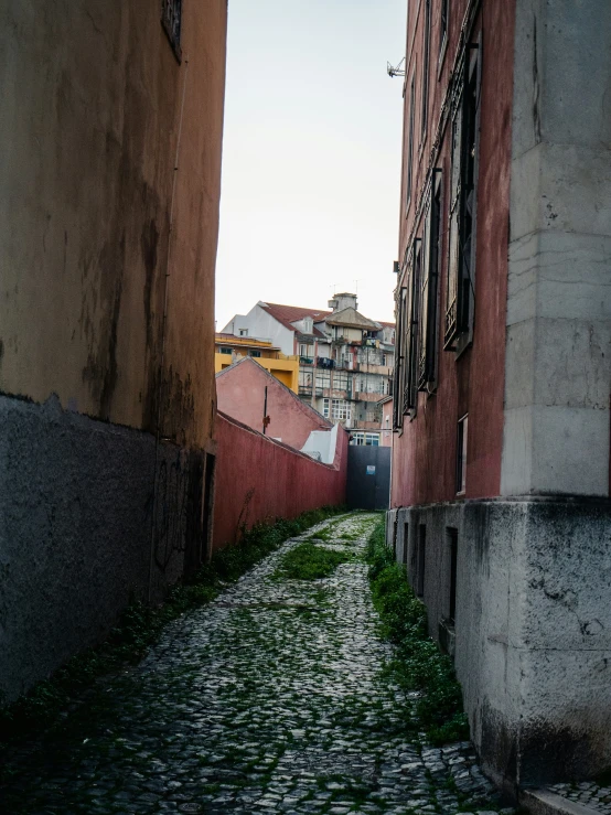 there is a long narrow street with buildings on both sides