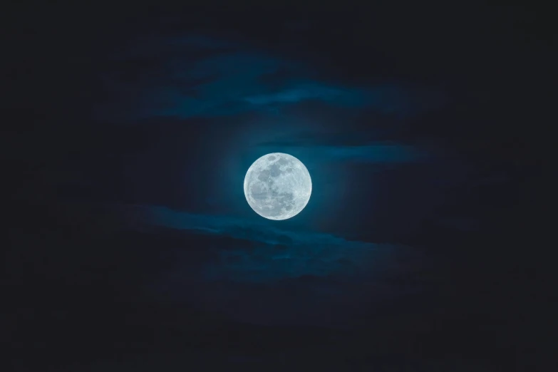 the moon is shining brightly above the clouds