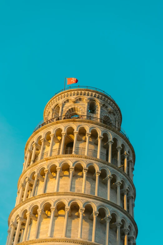 the flag is flying high on the top of a very tall building