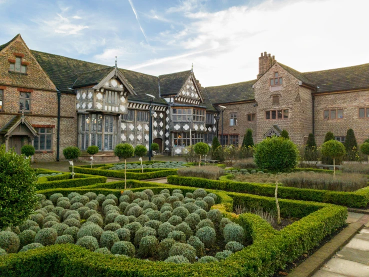 this large building has lots of hedges and shrubs