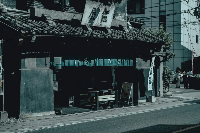 an old asian storefront on the corner of a street