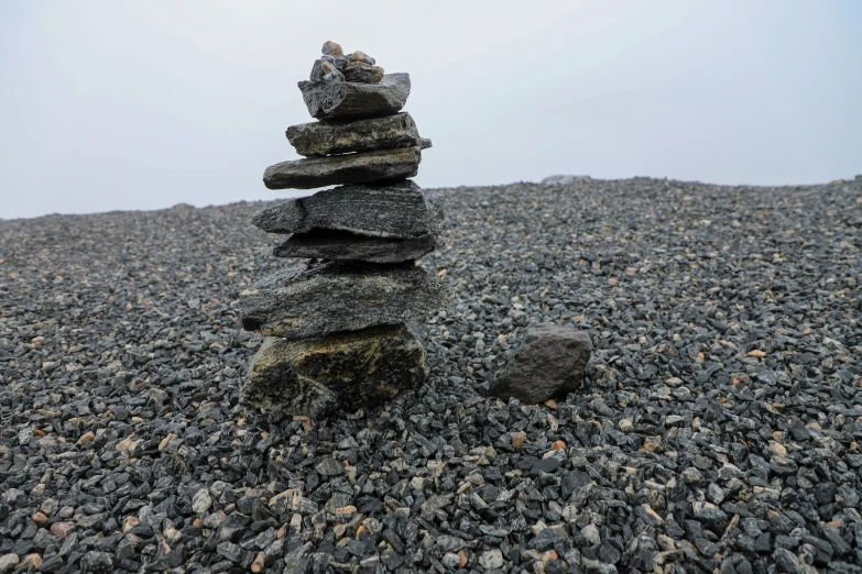 an image of stacked rocks on the beach