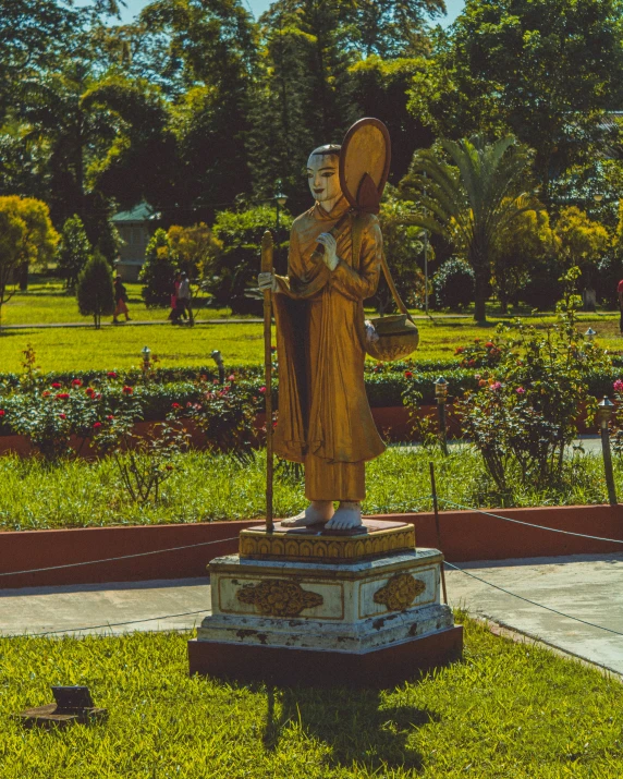 a sculpture of a man holding a hat and an umbrella