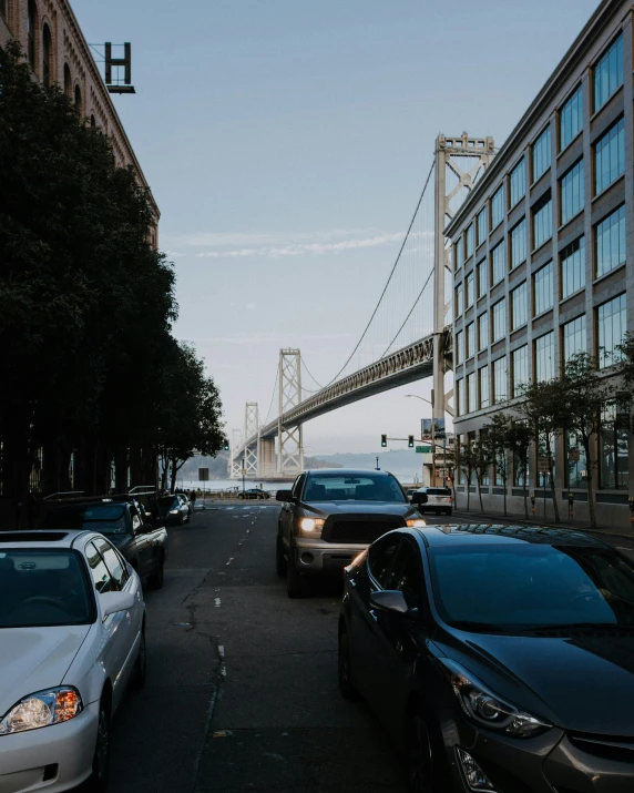 a very long bridge that is above the cars on a street