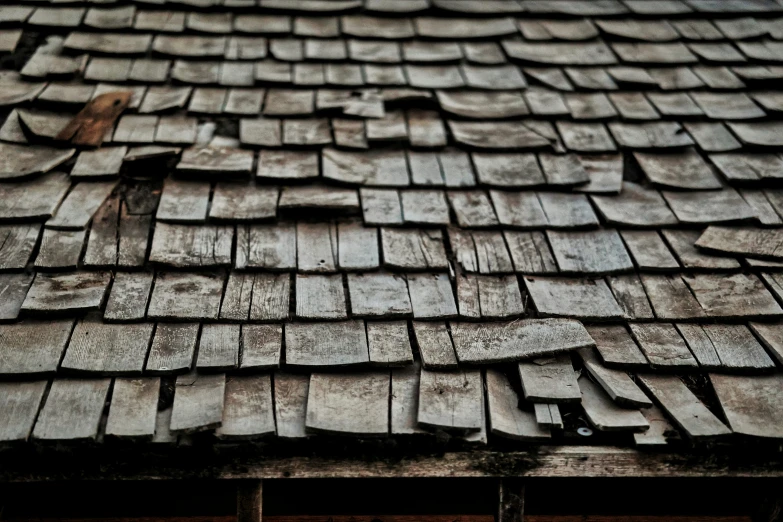 close up po of an old wooden roof with planks on the roof