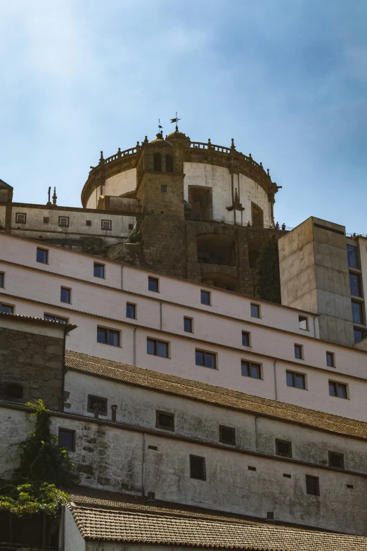 a very tall white building with a clock on the top