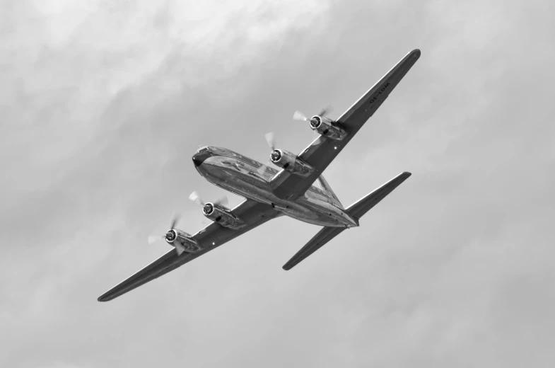 a plane is flying through the air during a cloudy day