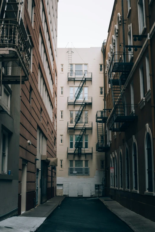 a narrow street lined with brick buildings and balconies