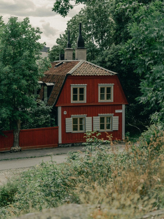 a red house that is next to some trees