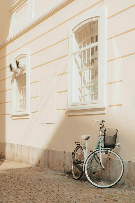 a bike parked next to a yellow building