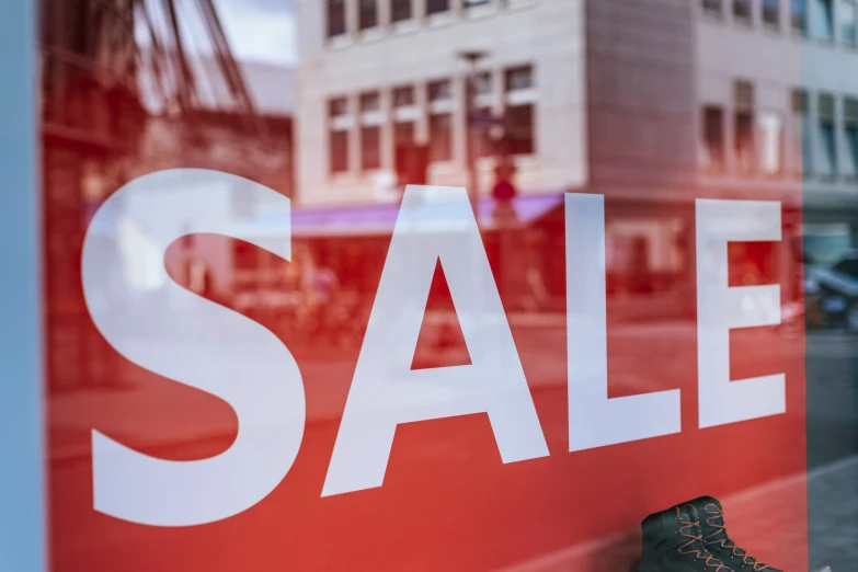 a sale sign hangs outside a store window