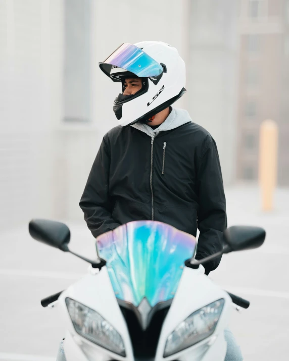 a person with a motorcylce helmet is standing by themselves