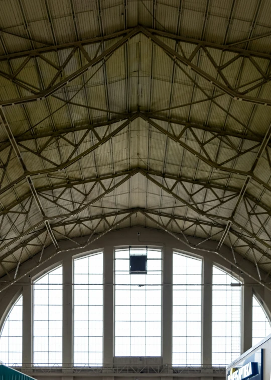 a large roof that has many windows with wires hanging from it