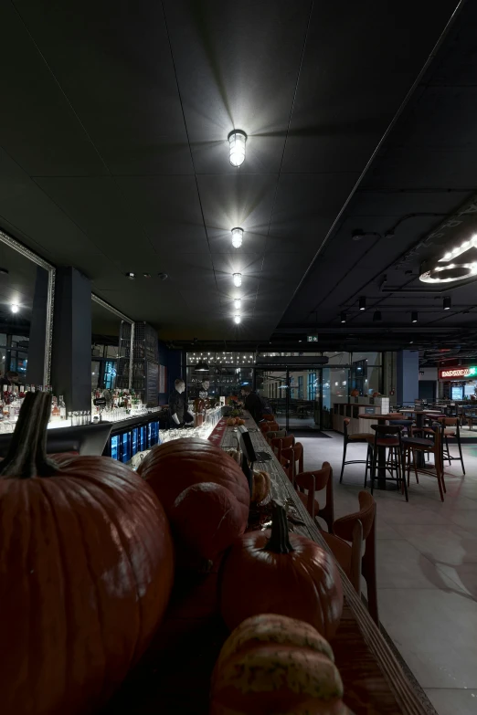 a restaurant with many large pumpkins on the tables