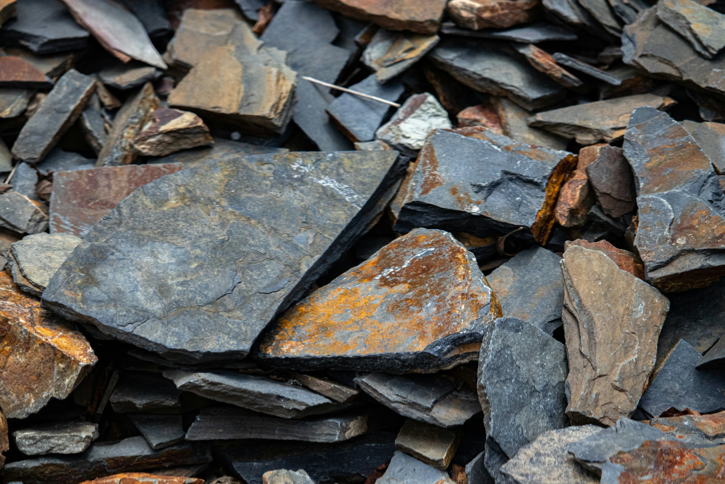 the pile of rocks is covered with rust