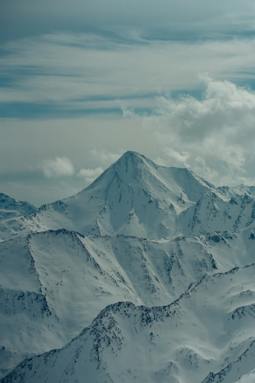 a large mountain range is seen with lots of snow