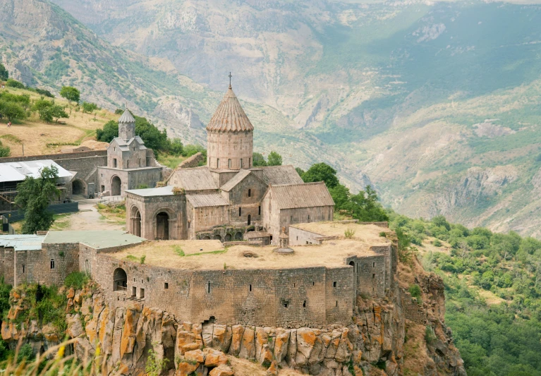 a large tower structure on a rocky mountain side