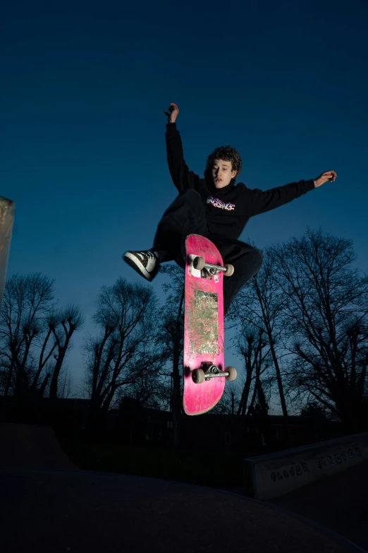 a young man riding a skateboard in the air