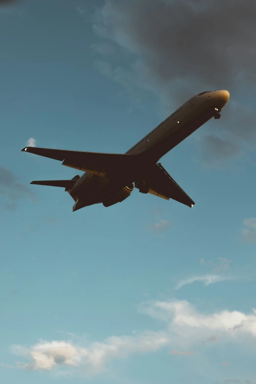 an airplane is flying in the air under a blue sky