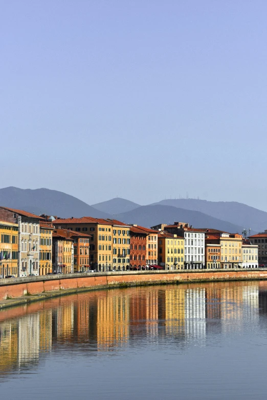 buildings by the water reflecting the sky