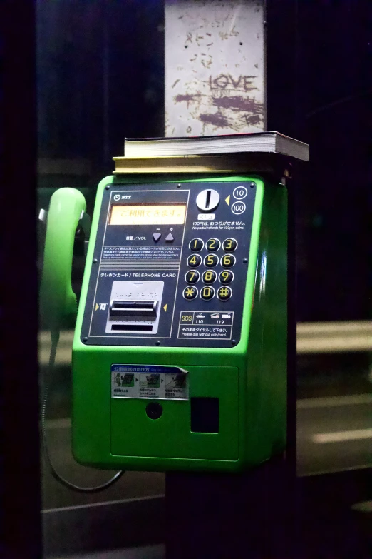 green vending machine sitting near a building