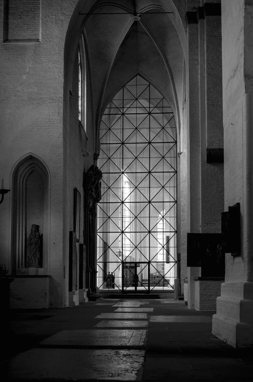 a long white hallway with archways and a clock