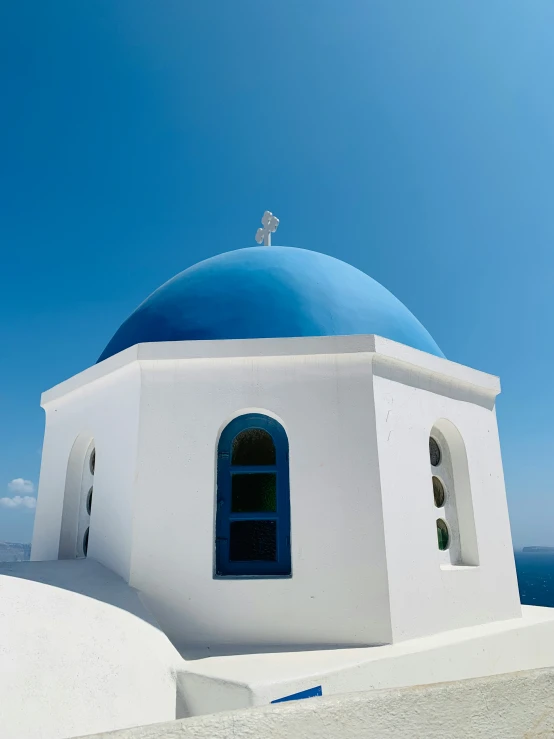 a large white and blue building on top of a hill