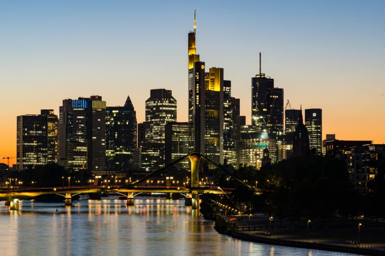 a large city skyline with lights shine over a large body of water