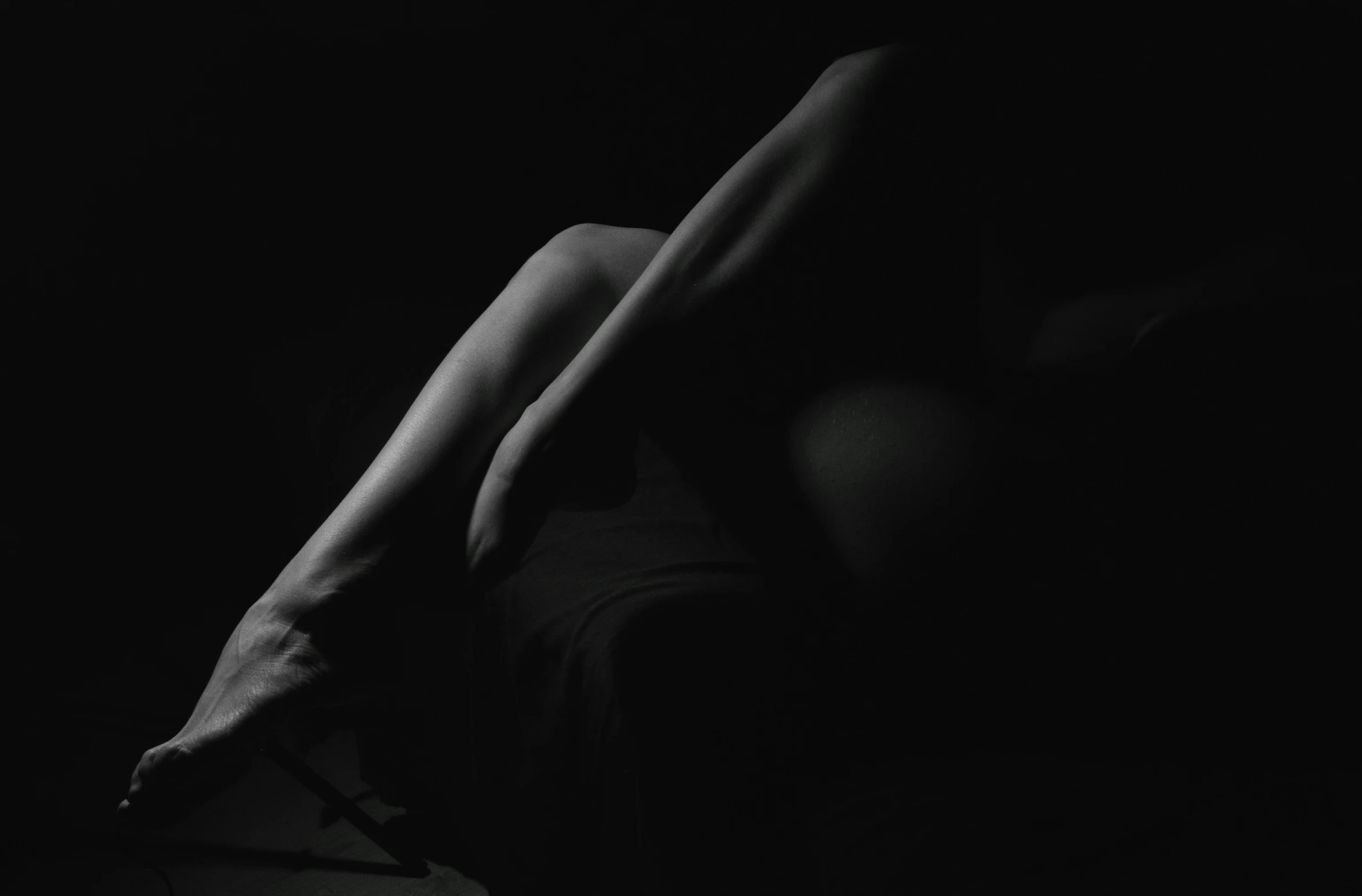 the top half of a women's body in a darkened room