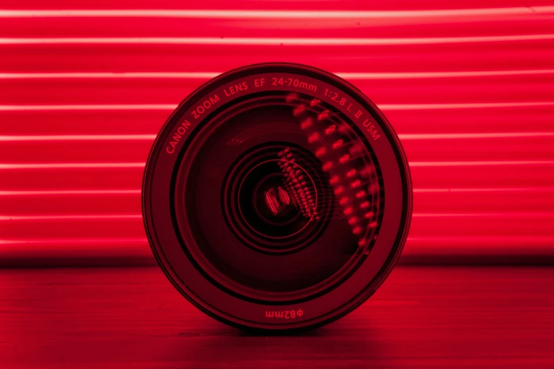 red blurry image of a lens on a table