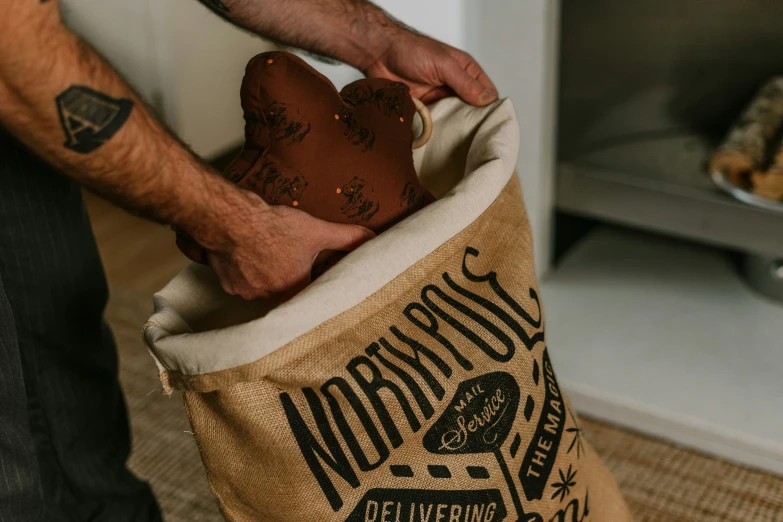 a person is holding a bag filled with doughnuts