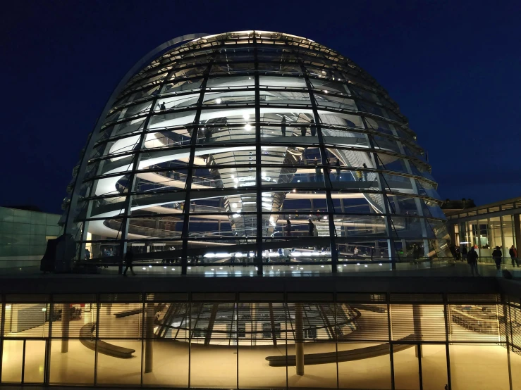 a building made of glass and lit up by the lights