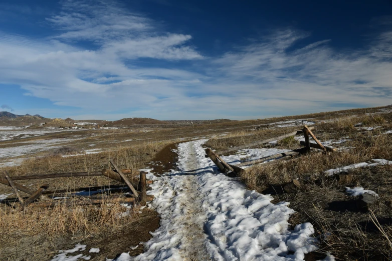 a road is covered with snow in the field