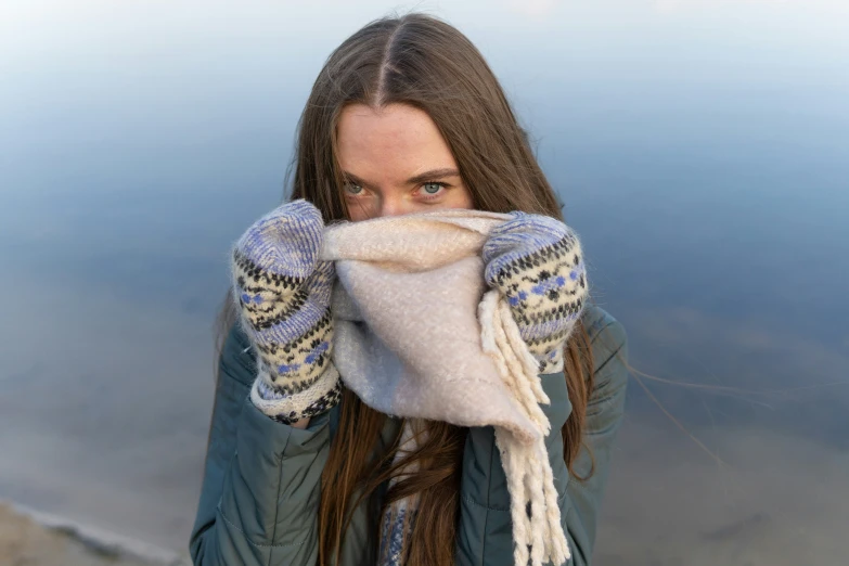 a woman with a white blanket covering her eyes