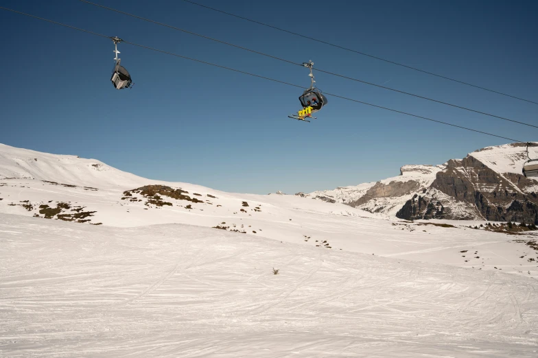 skiers in ski gear going down a snowy slope