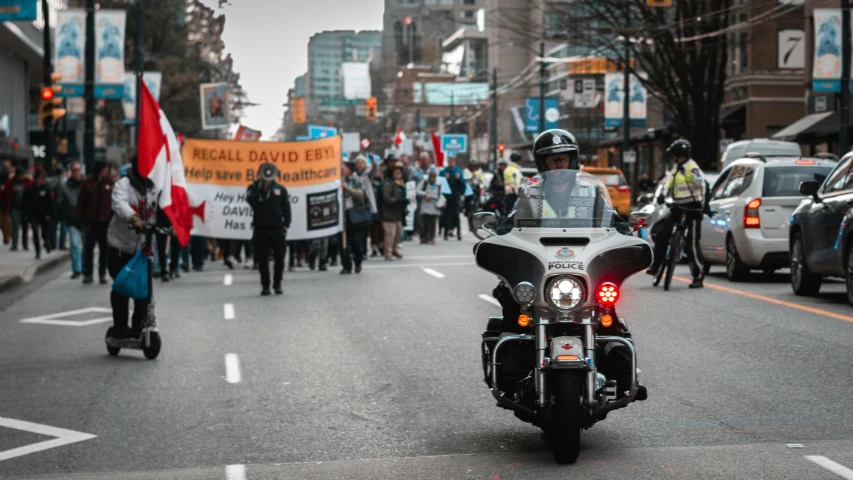 a motorcyclist driving down the street during a demonstration