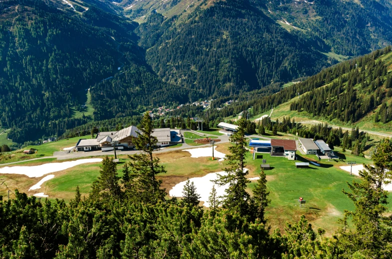 a view of an area with houses, buildings and mountains in the background