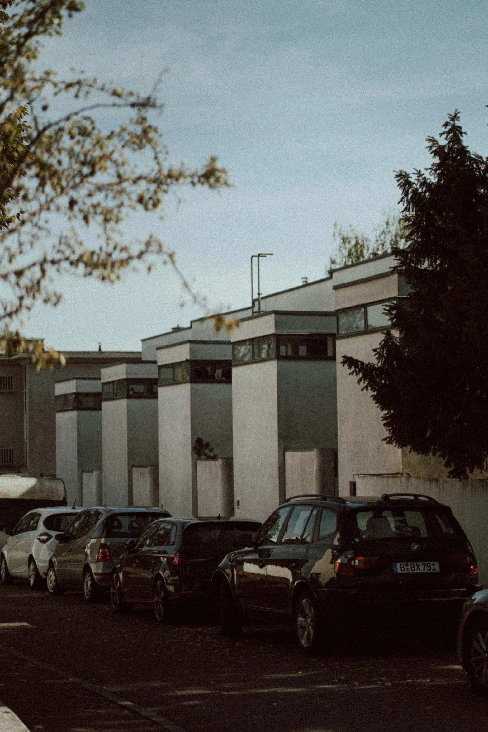 a street scene with cars parked in front of large building