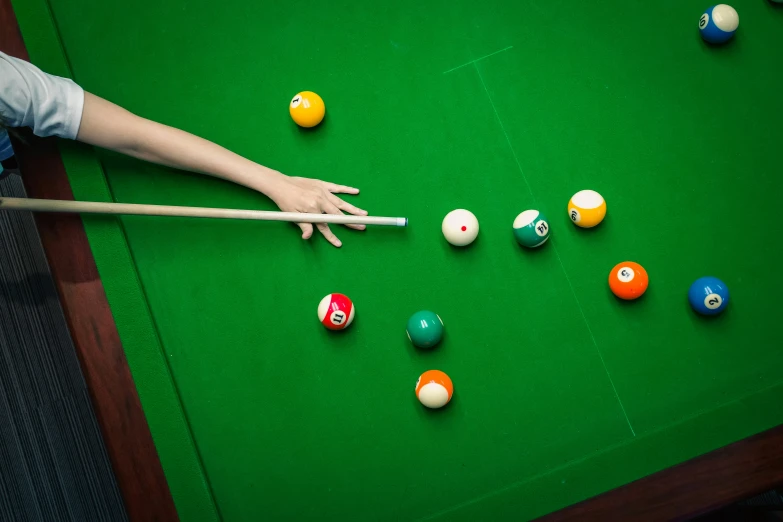 several pool balls are laid out on a green table