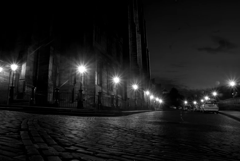 black and white po of a cobblestone street at night